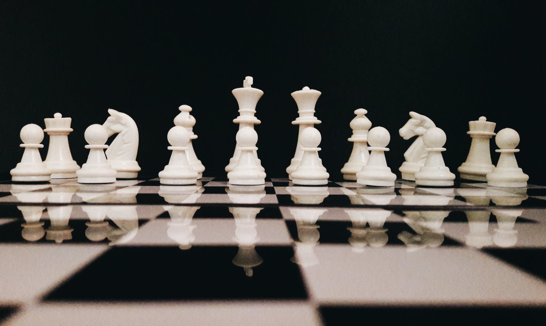 white chess piece on top of chess board